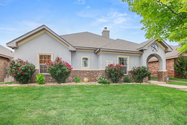 7404 Southbend Dr, Amarillo, TX 79119 - view of front of house with brick siding, stucco siding, a front lawn, and a shingled roof