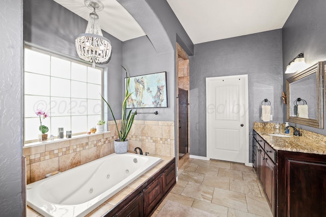 7404 Southbend Dr, Amarillo, TX 79119 - full bathroom featuring a jetted tub, vanity, a chandelier, a shower stall, and stone finish floors