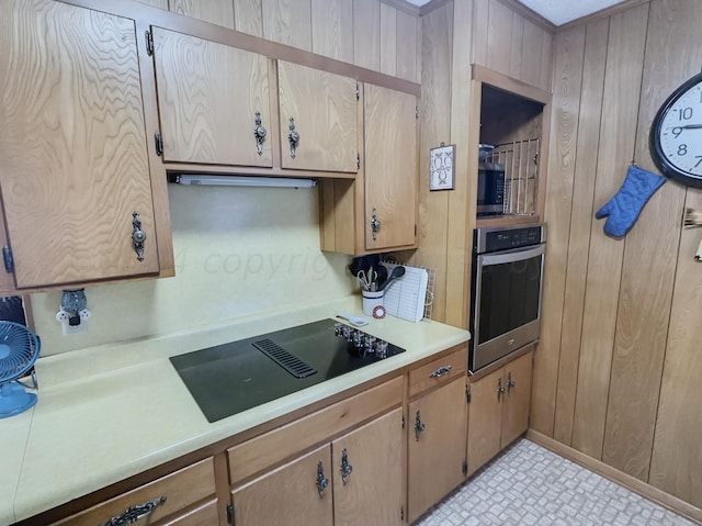 kitchen with wooden walls and appliances with stainless steel finishes