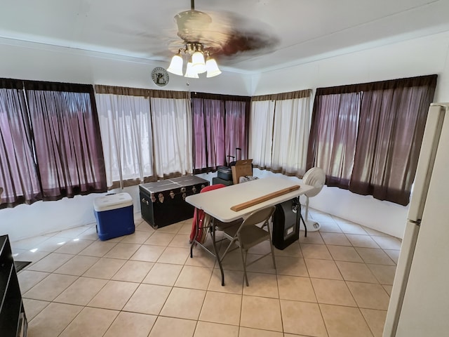 tiled dining space with ceiling fan