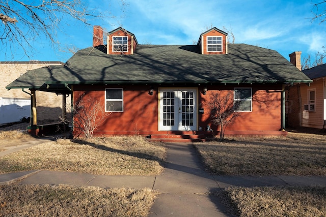 view of front of property featuring a front yard and french doors