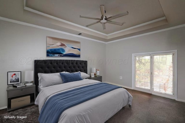 bedroom with a tray ceiling, carpet, baseboards, ornamental molding, and access to exterior