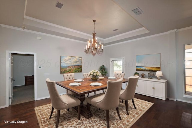 dining room featuring visible vents, a tray ceiling, a chandelier, and dark wood-style flooring