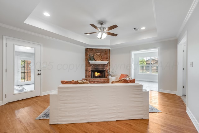 6100 Mckay Ct, Amarillo, TX 79118 - living room featuring a raised ceiling, light wood-type flooring, a ceiling fan, ornamental molding, and recessed lighting