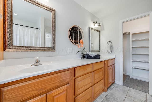 6100 Mckay Ct, Amarillo, TX 79118 - full bath featuring double vanity, tile patterned flooring, and a walk in closet
