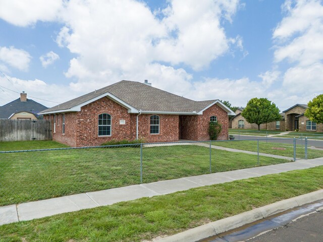 6100 Mckay Ct, Amarillo, TX 79118 - ranch-style house with brick siding, roof with shingles, and a fenced front yard