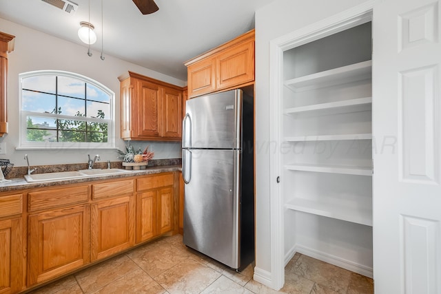 6100 Mckay Ct, Amarillo, TX 79118 - kitchen with freestanding refrigerator, dark countertops, built in features, and ceiling fan