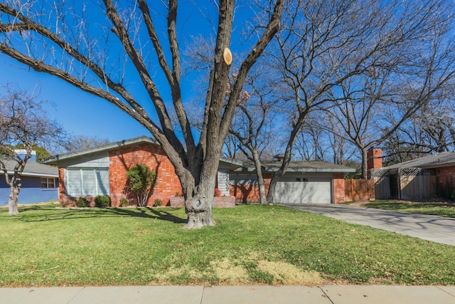 ranch-style home featuring a garage and a front yard