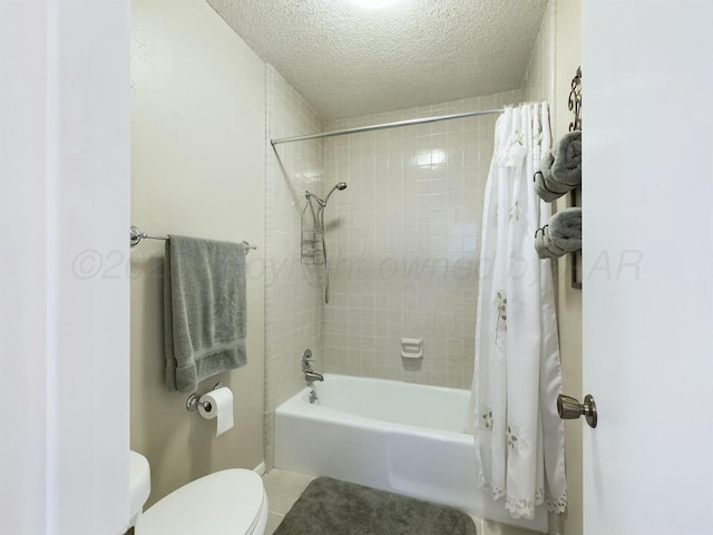 bathroom featuring shower / bath combo, tile patterned floors, a textured ceiling, and toilet