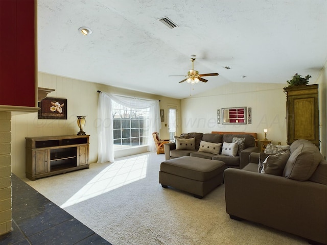 carpeted living room featuring ceiling fan and vaulted ceiling