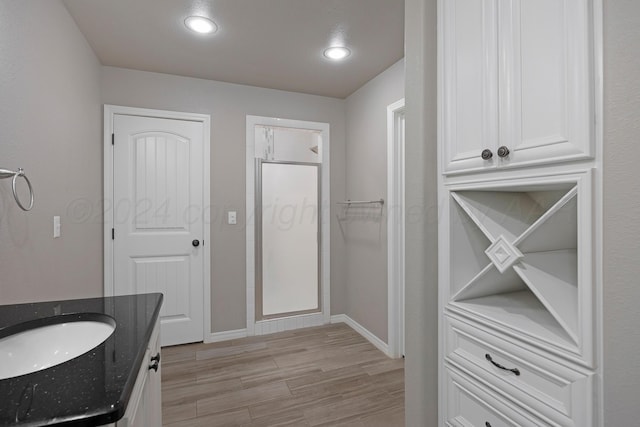 bathroom featuring hardwood / wood-style floors and vanity