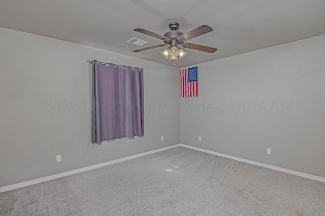 spare room featuring ceiling fan and carpet floors