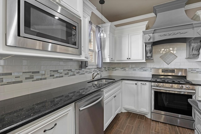 kitchen featuring white cabinetry, sink, dark hardwood / wood-style floors, crown molding, and appliances with stainless steel finishes