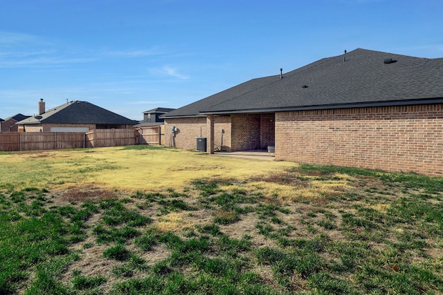 back of house with a lawn and cooling unit