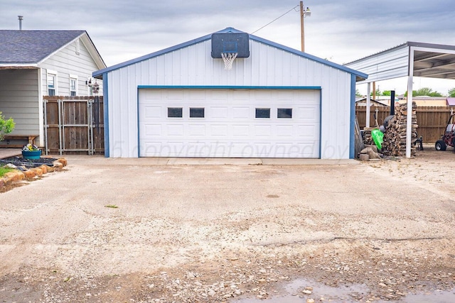 detached garage featuring fence
