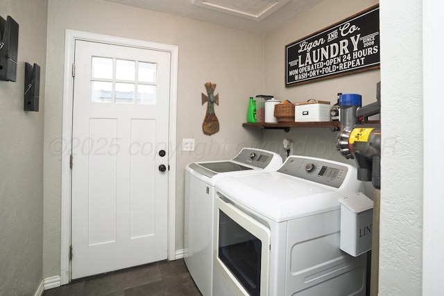 clothes washing area featuring independent washer and dryer, laundry area, and baseboards