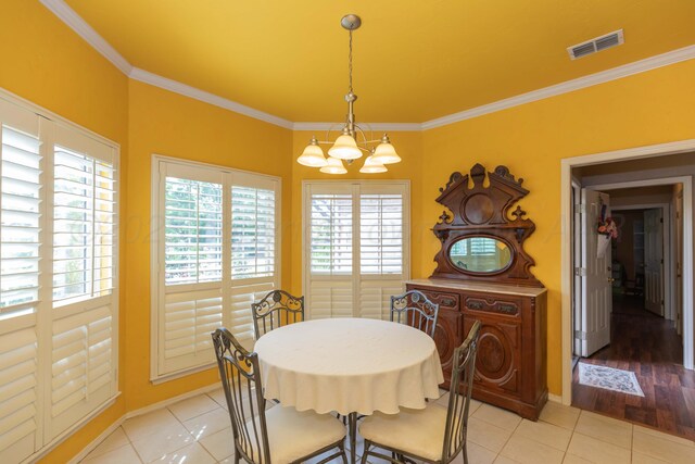 6702 Opal Ct, Amarillo, TX 79124 - dining room with a chandelier, ornamental molding, light tile patterned flooring, and baseboards