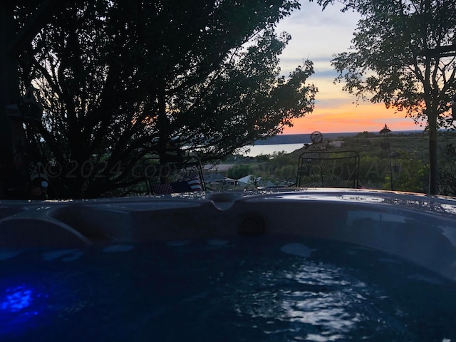 view of pool at dusk