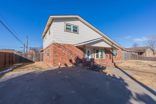 view of front of property with fence and brick siding