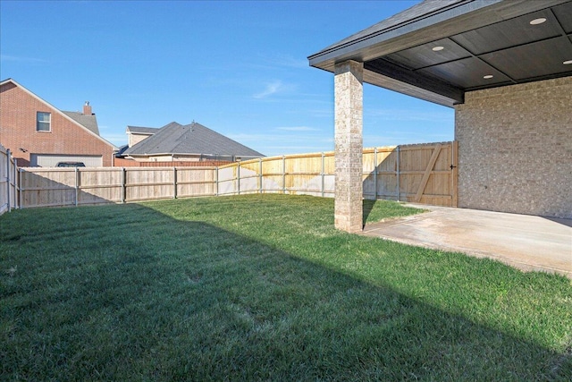 view of yard with a patio area and a fenced backyard