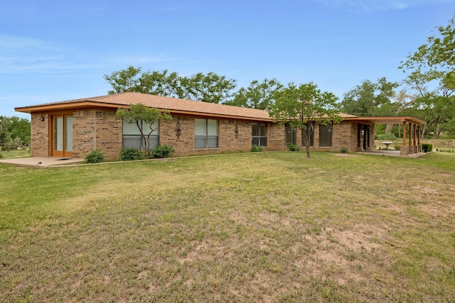 back of property featuring a yard