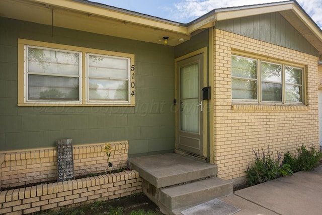 property entrance with brick siding