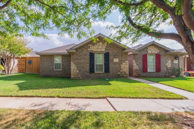 ranch-style home featuring a front yard