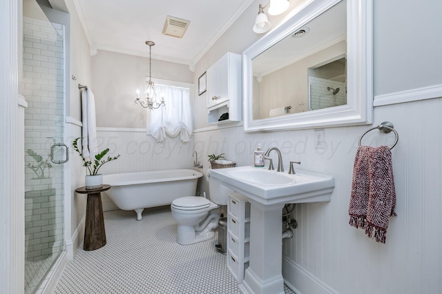501 Sunset Ter, Amarillo, TX 79106 - full bathroom featuring a shower stall, toilet, a freestanding tub, a chandelier, and wainscoting