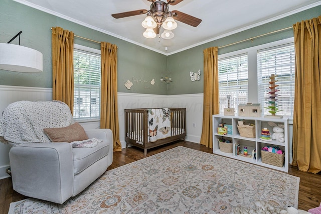 501 Sunset Ter, Amarillo, TX 79106 - bedroom with wood finished floors, a wainscoted wall, a nursery area, ornamental molding, and a ceiling fan