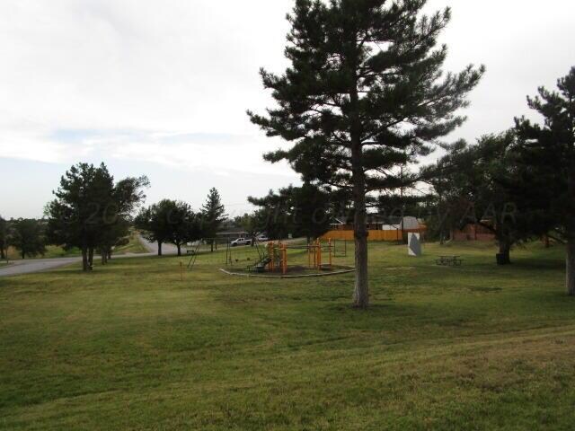 view of property's community with a lawn