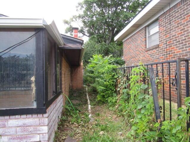 view of side of property featuring a sunroom