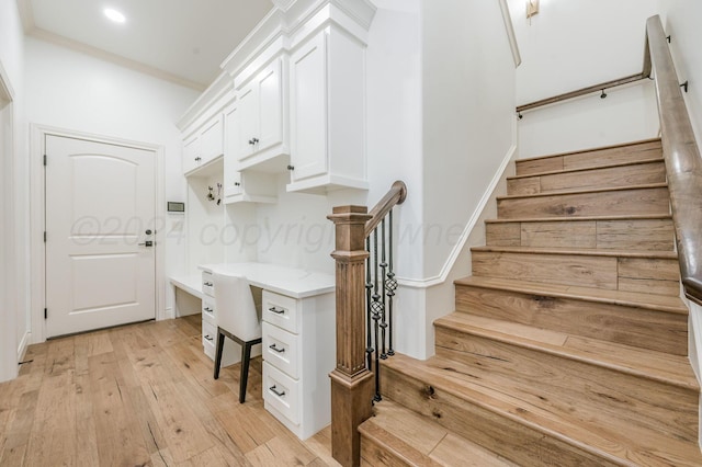 stairs featuring hardwood / wood-style floors