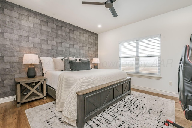 bedroom featuring hardwood / wood-style flooring and ceiling fan