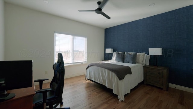 bedroom with ceiling fan and dark wood-type flooring