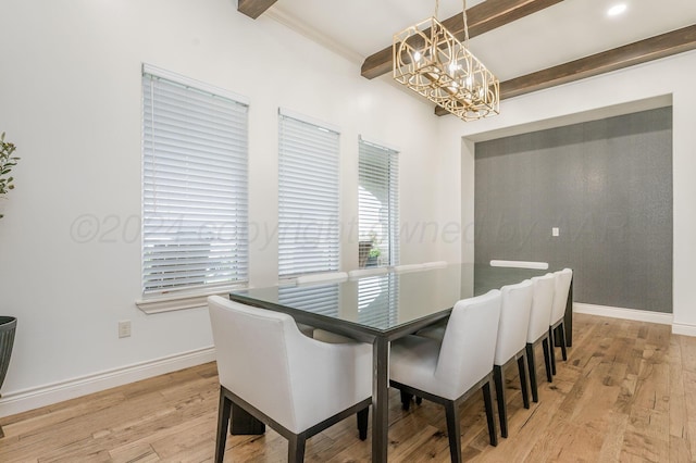 dining room featuring beam ceiling, a notable chandelier, and light wood-type flooring