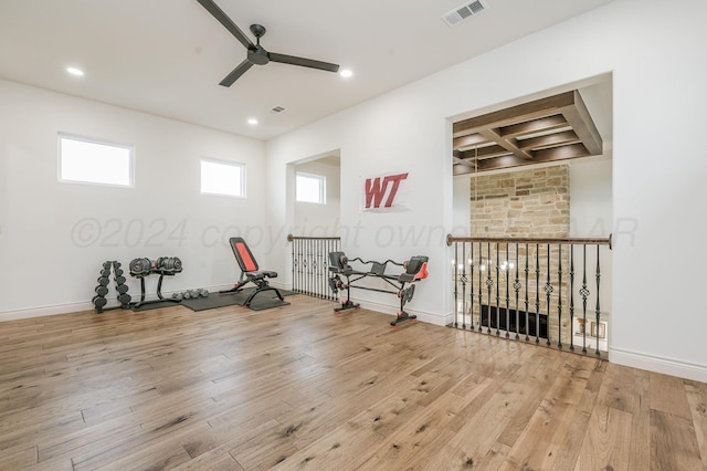 exercise area with light wood-type flooring and ceiling fan