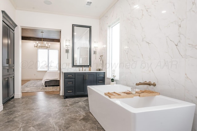 bathroom with vanity, a chandelier, tile walls, and ornamental molding