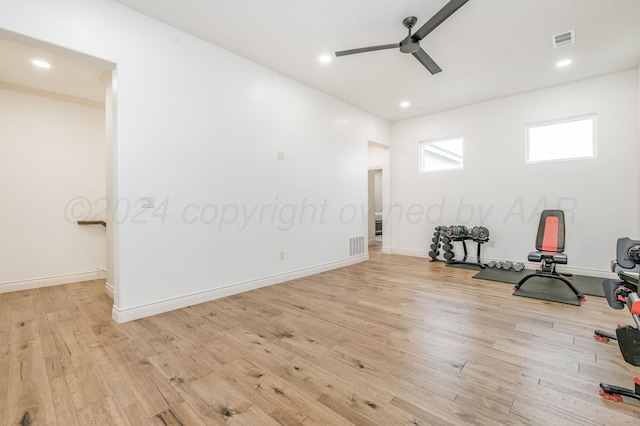 workout area with ceiling fan and light hardwood / wood-style flooring