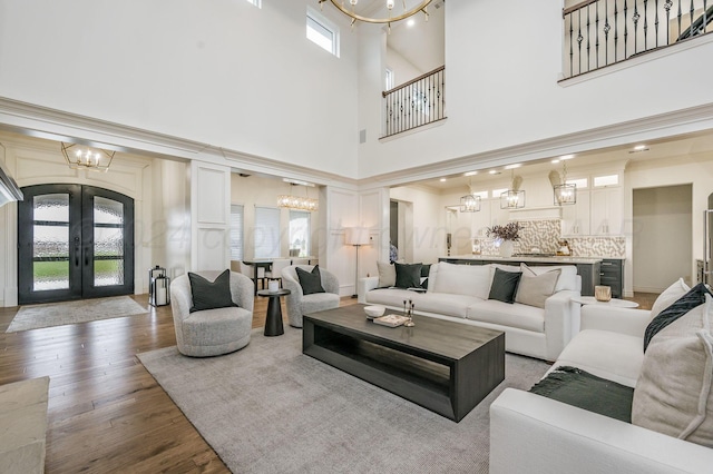 living room featuring a high ceiling, dark hardwood / wood-style floors, and french doors