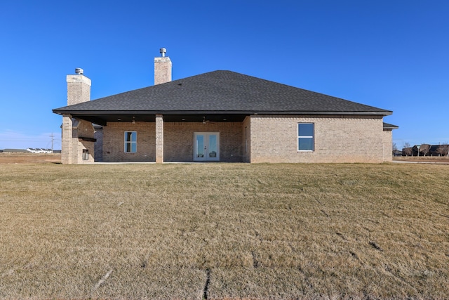 back of house with a lawn and french doors