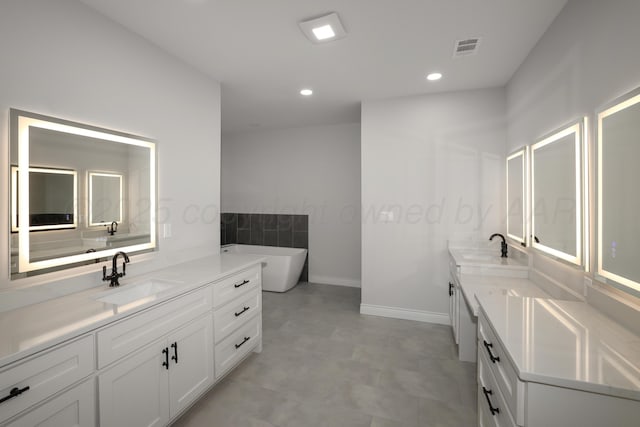 bathroom with a tub to relax in and vanity