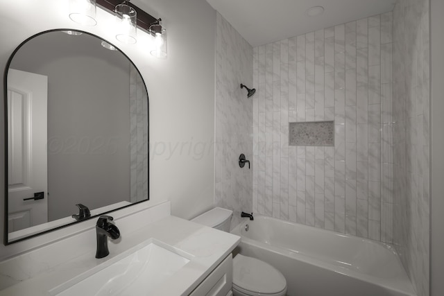 full bathroom with toilet, vanity, and tiled shower / bath