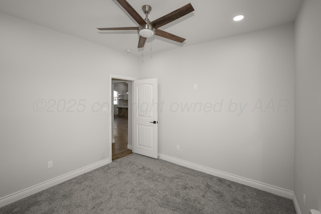 carpeted spare room with ceiling fan