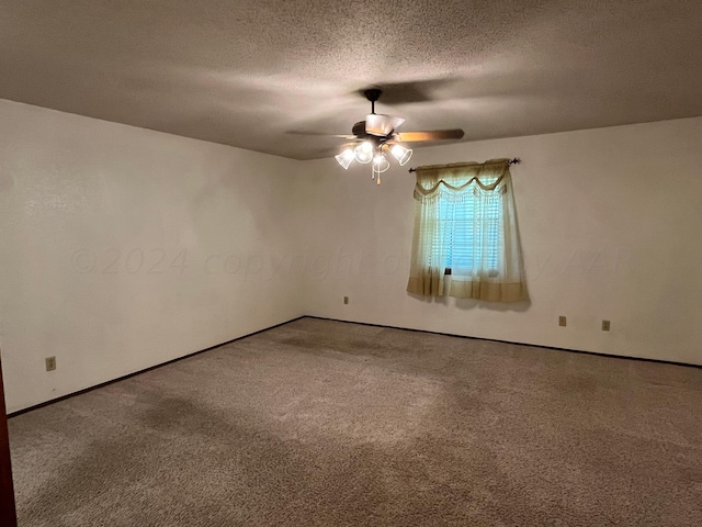 spare room with carpet flooring, a textured ceiling, and ceiling fan