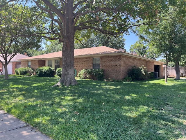 view of side of home with a lawn