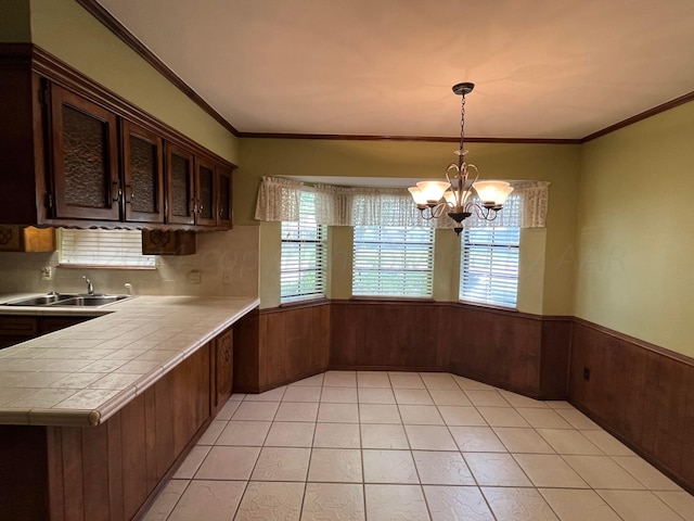 kitchen featuring kitchen peninsula, a wealth of natural light, hanging light fixtures, and decorative backsplash