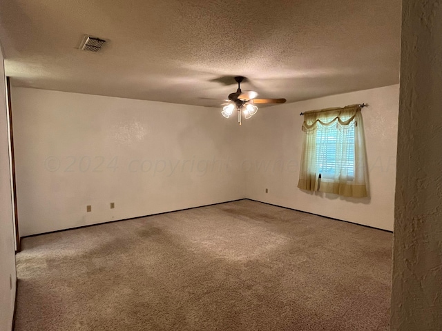 unfurnished room with carpet, a textured ceiling, and ceiling fan