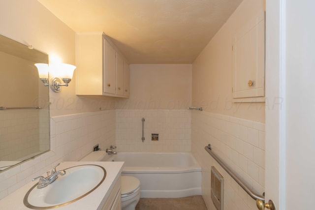 bathroom featuring a bathing tub, vanity, tile walls, and toilet