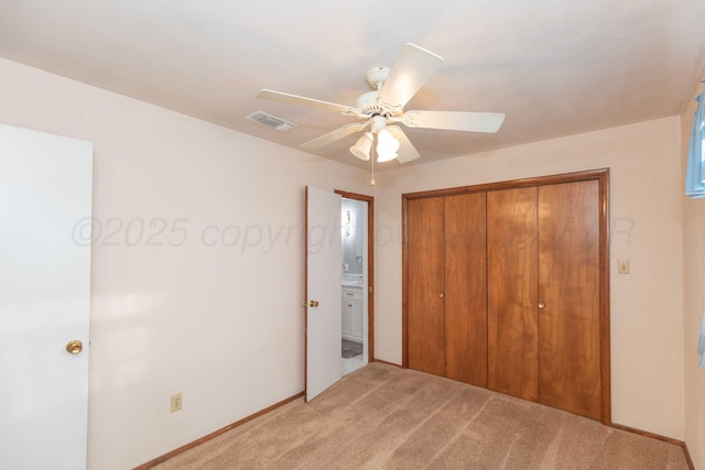 unfurnished bedroom featuring ceiling fan, light carpet, and a closet