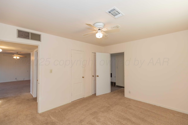 carpeted spare room with ceiling fan